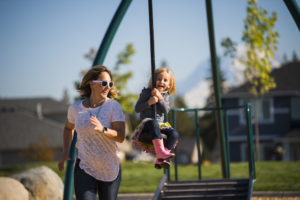 Mother and daughter play on zipline at park