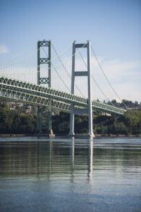 The Tacoma Narrows Bridge and a reflection of it in the water below